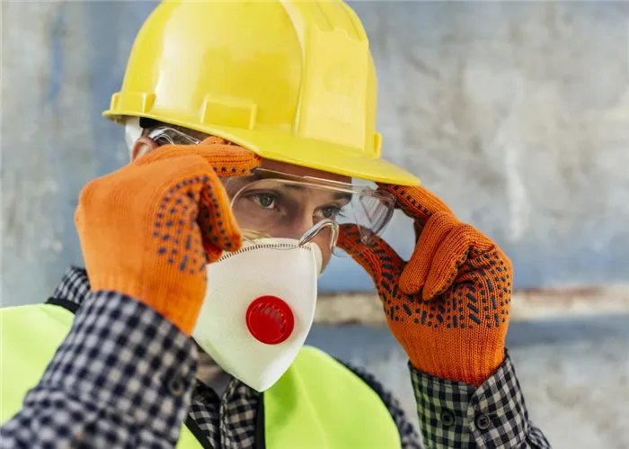 worker-adjusting-his-protective-glasses-while-wearing-mask-and-gloves-scaled.jpg